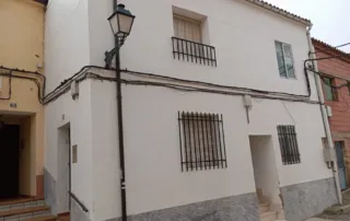 la fachada de una casa de dos plantas en un barrio residencial.